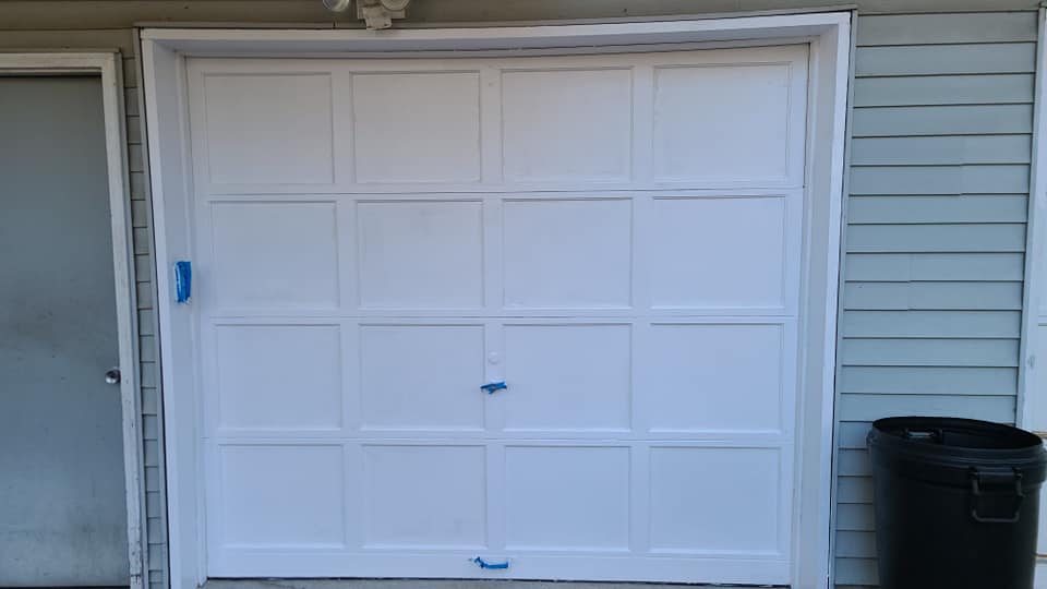 Garage door with peeling paint, before